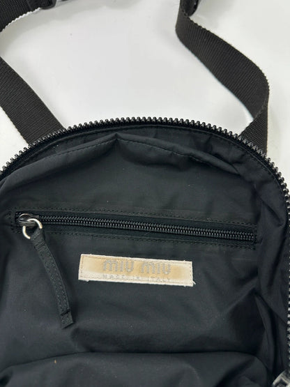 Miu Miu grey mesh 2-in-1 chest bag backpack with faded logo and minimalist design.