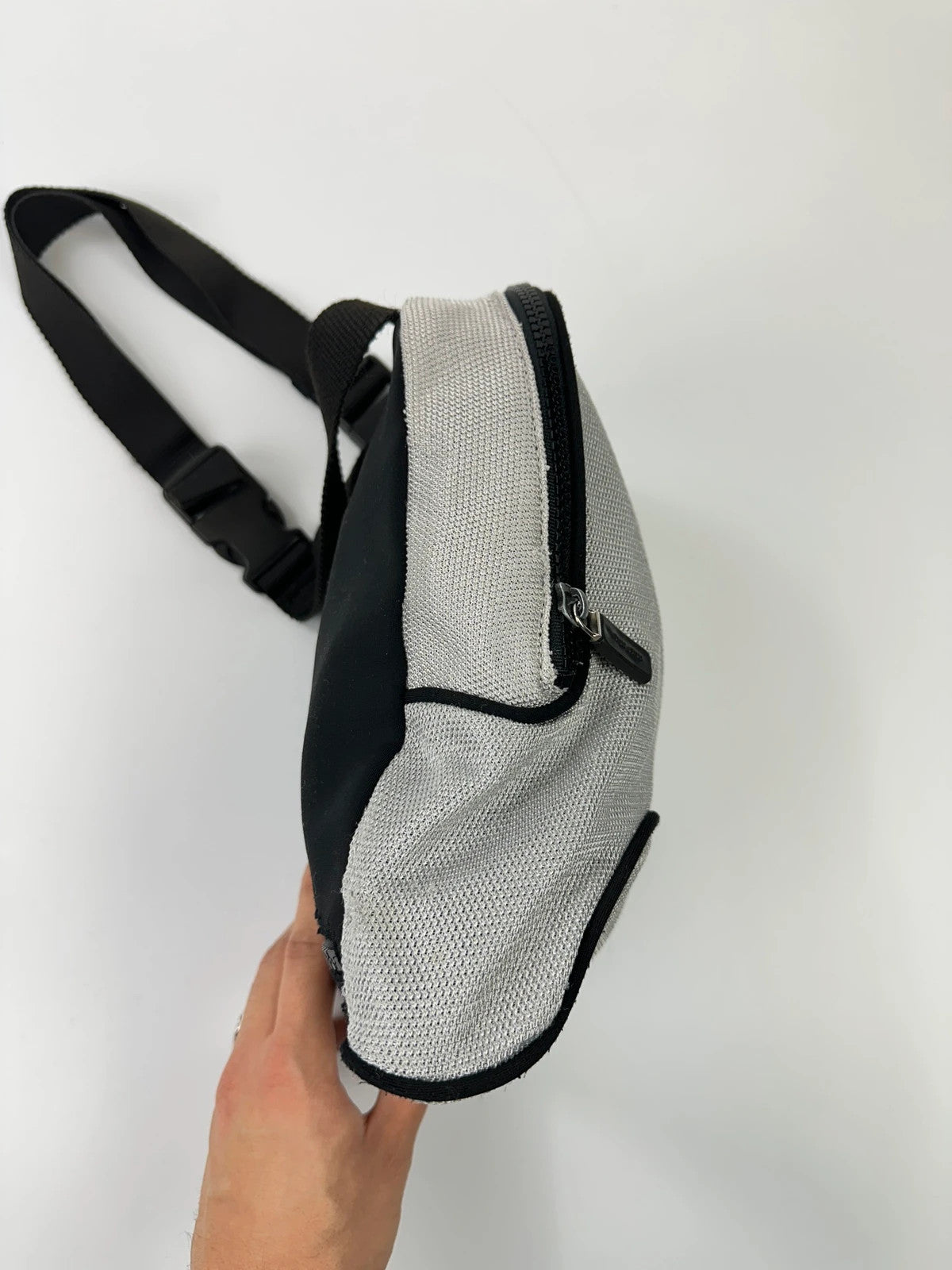 Miu Miu grey mesh 2in1 chest bag backpack, faded logo, minimalist design.