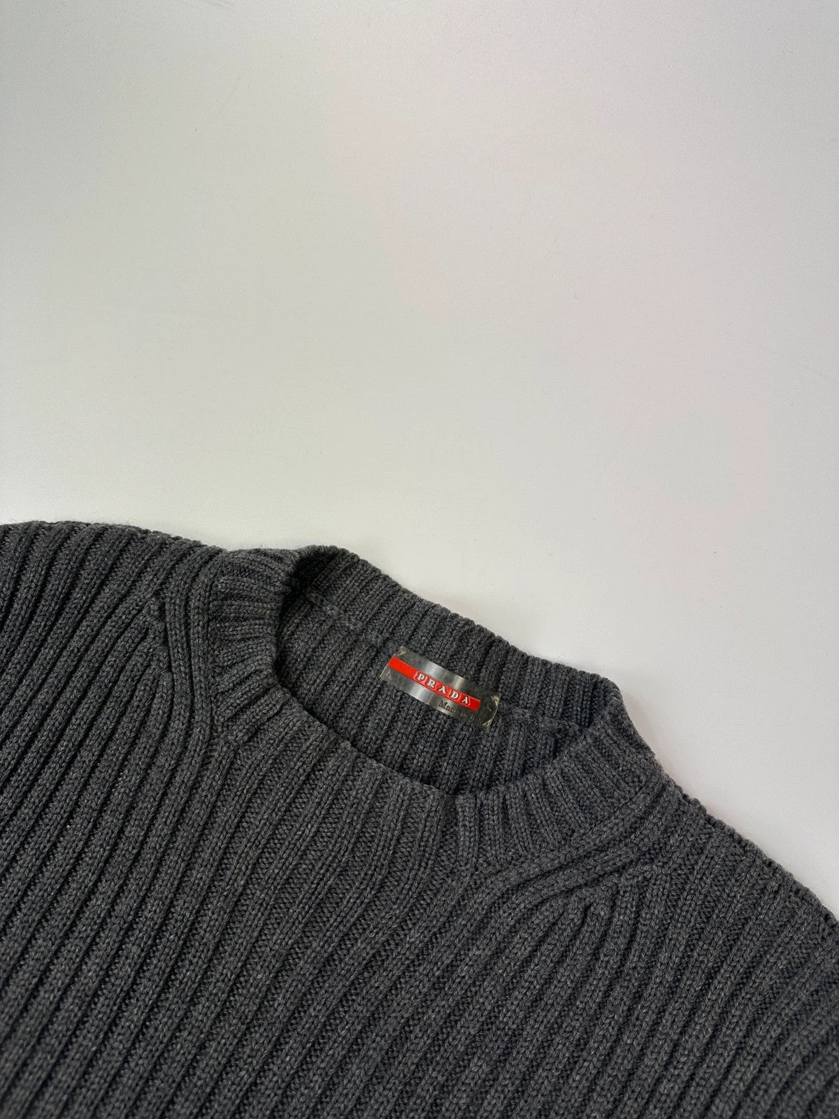 Prada grey ribbed wool knit sweater with elbow seam detailing from FW2004 collection.