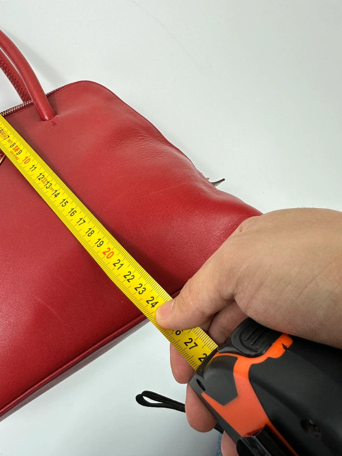 Prada red leather handbag with gold hardware and vintage logo detail.