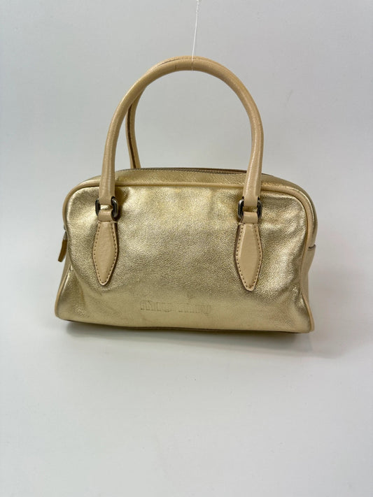 Miu Miu gold leather mini handbag with shiny glitter finish and logo detail.