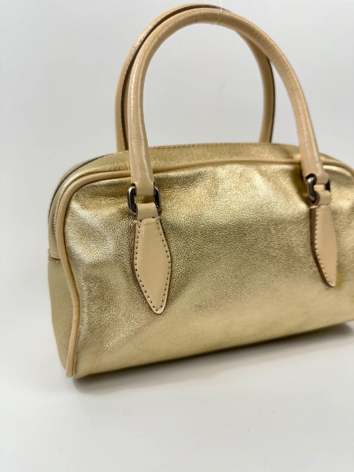 Miu Miu gold leather mini handbag with shiny glitter finish and logo detail.