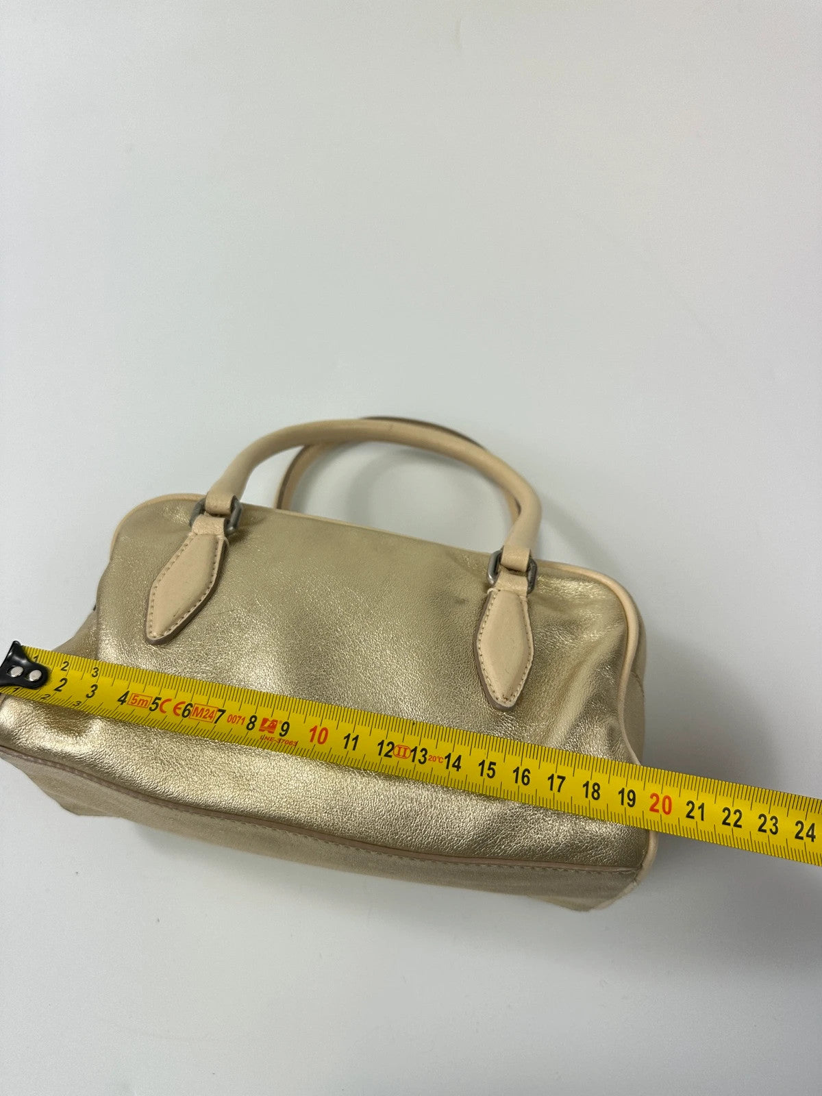 Miu Miu gold leather mini handbag with shiny glitter finish and logo detail.