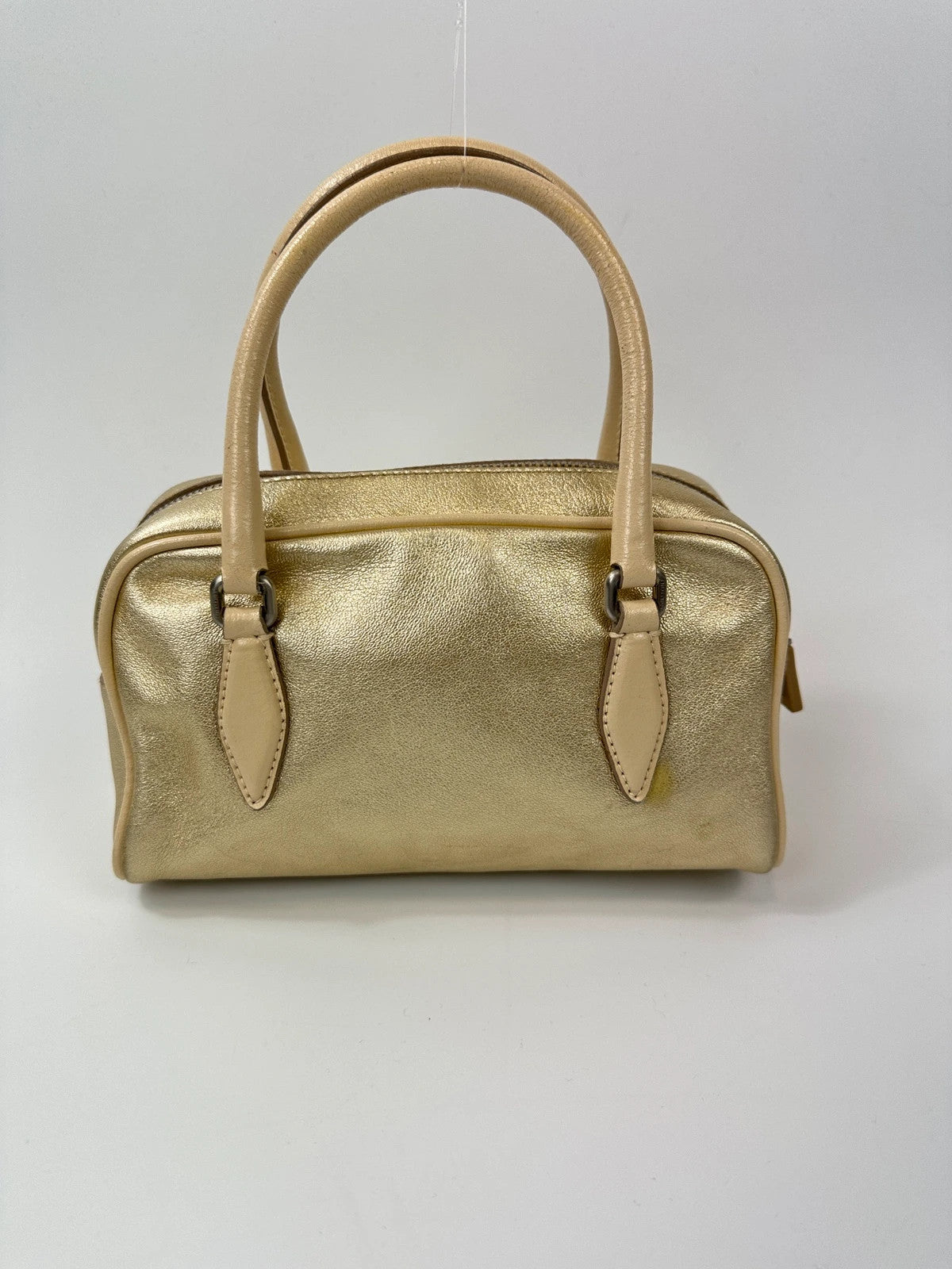 Miu Miu gold leather mini handbag with shiny glitter finish and logo detail.