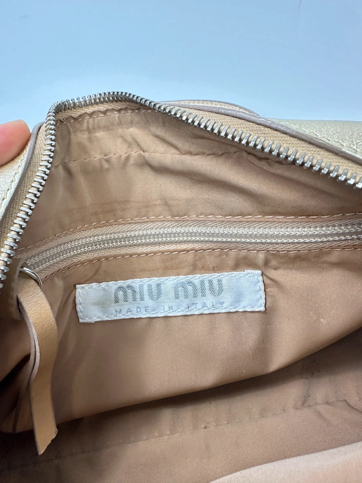 Miu Miu gold leather mini handbag with shiny glitter finish and logo detail.