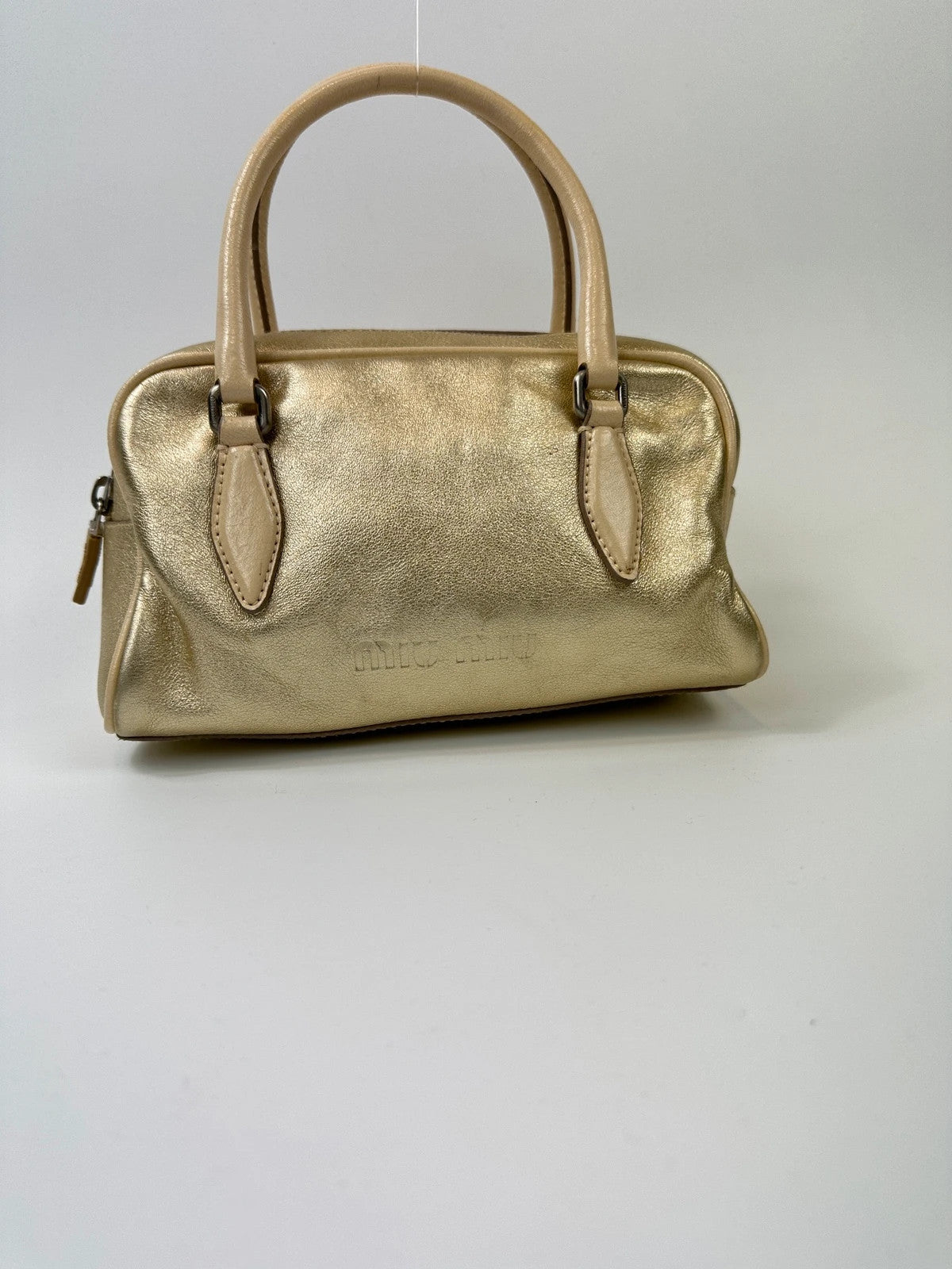 Miu Miu gold leather mini handbag with shiny glitter finish and logo detail.