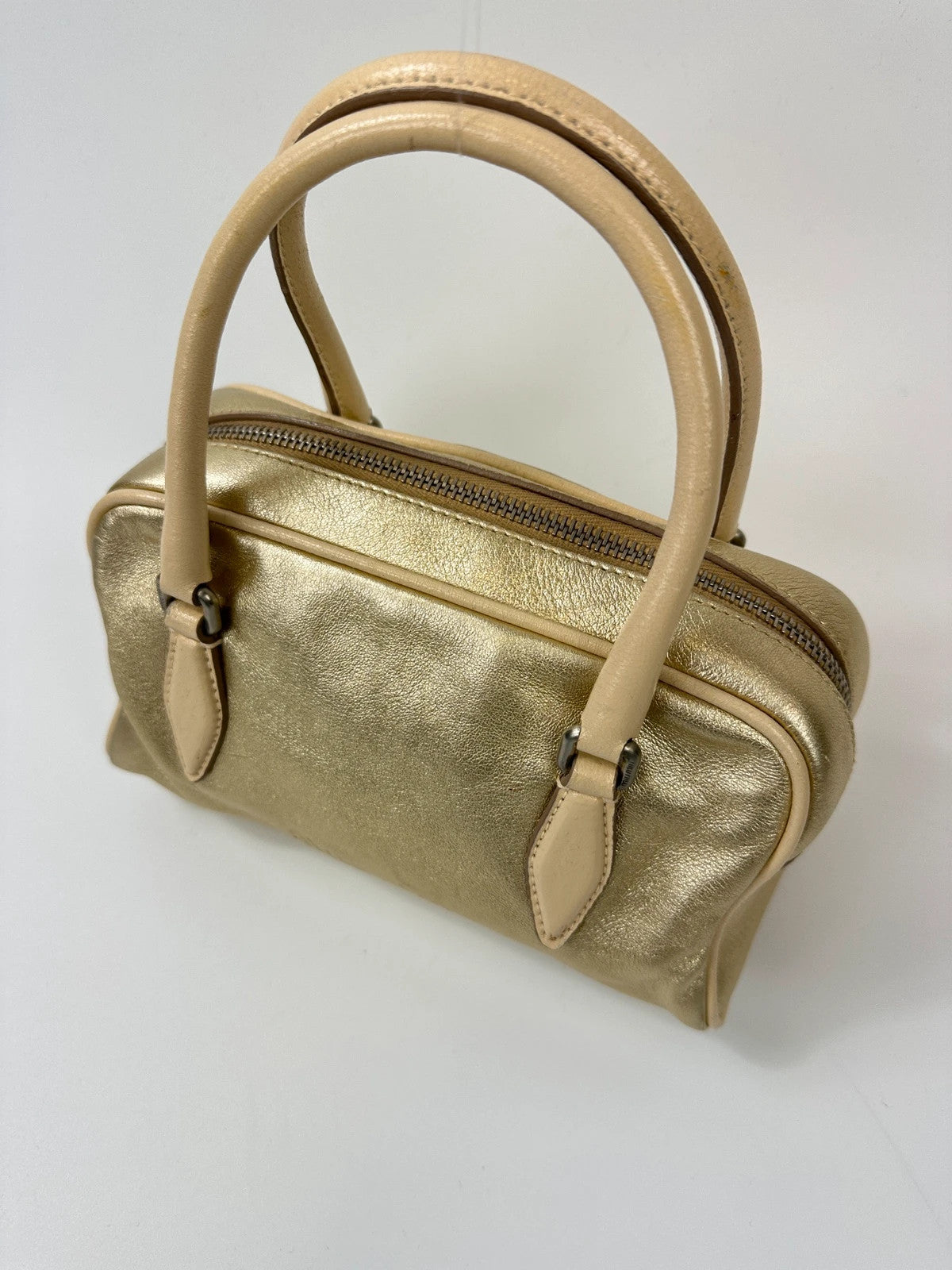 Miu Miu gold leather mini handbag with shiny glitter finish and logo detail.