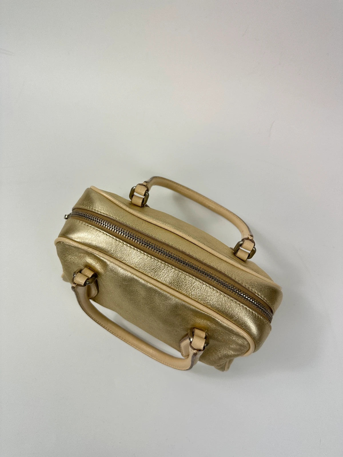 Miu Miu gold leather mini handbag with shiny glitter finish and logo detail.