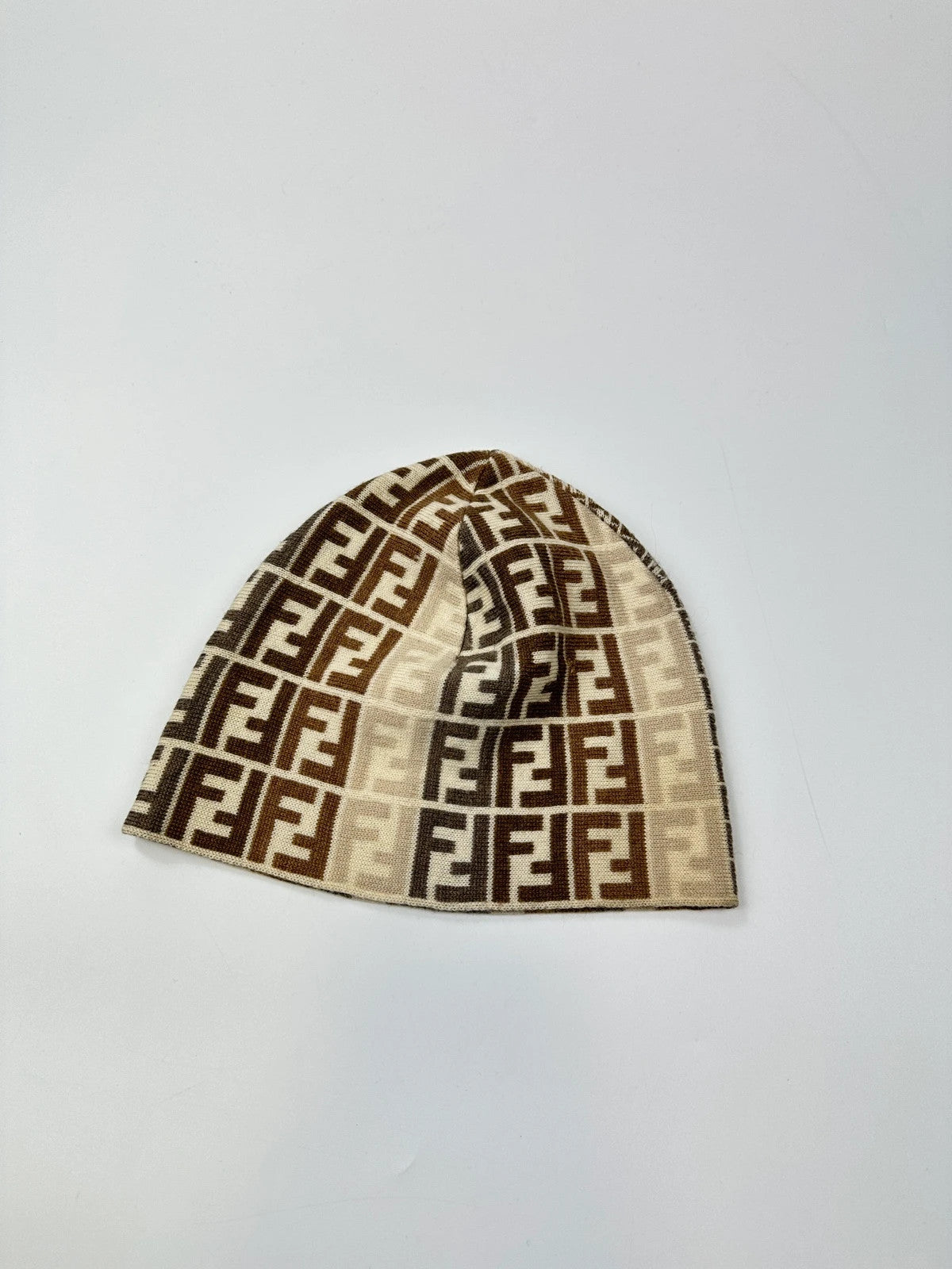 Fendi beige brown beanie featuring iconic monogram pattern and soft wool material.
