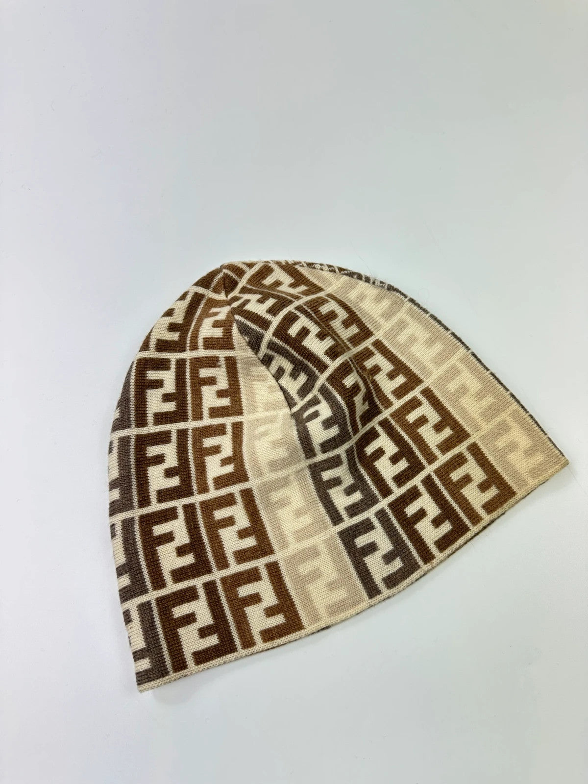 Fendi beige brown beanie featuring iconic monogram pattern and soft wool material.