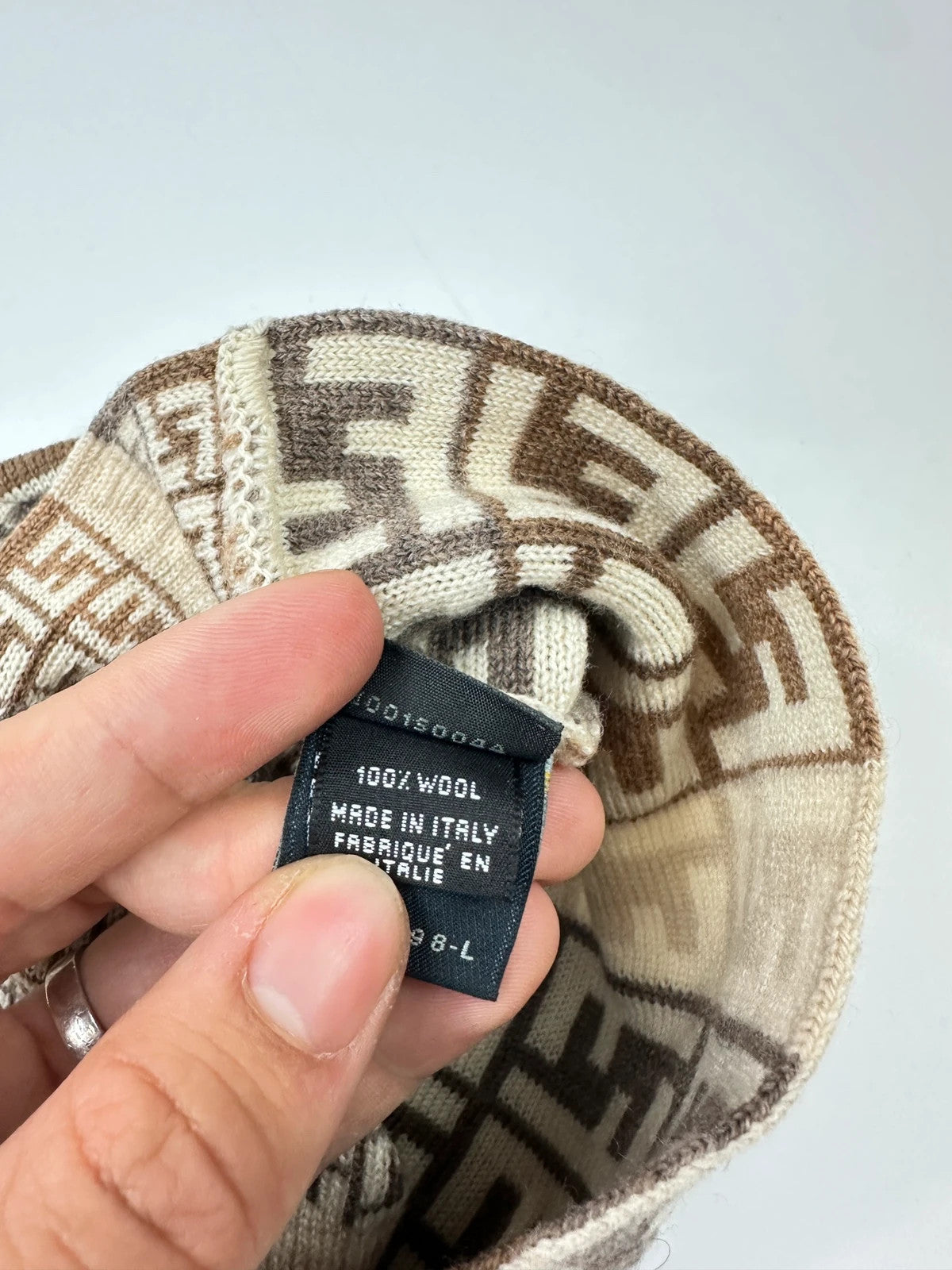 Fendi beige brown beanie featuring iconic monogram pattern and soft wool material.