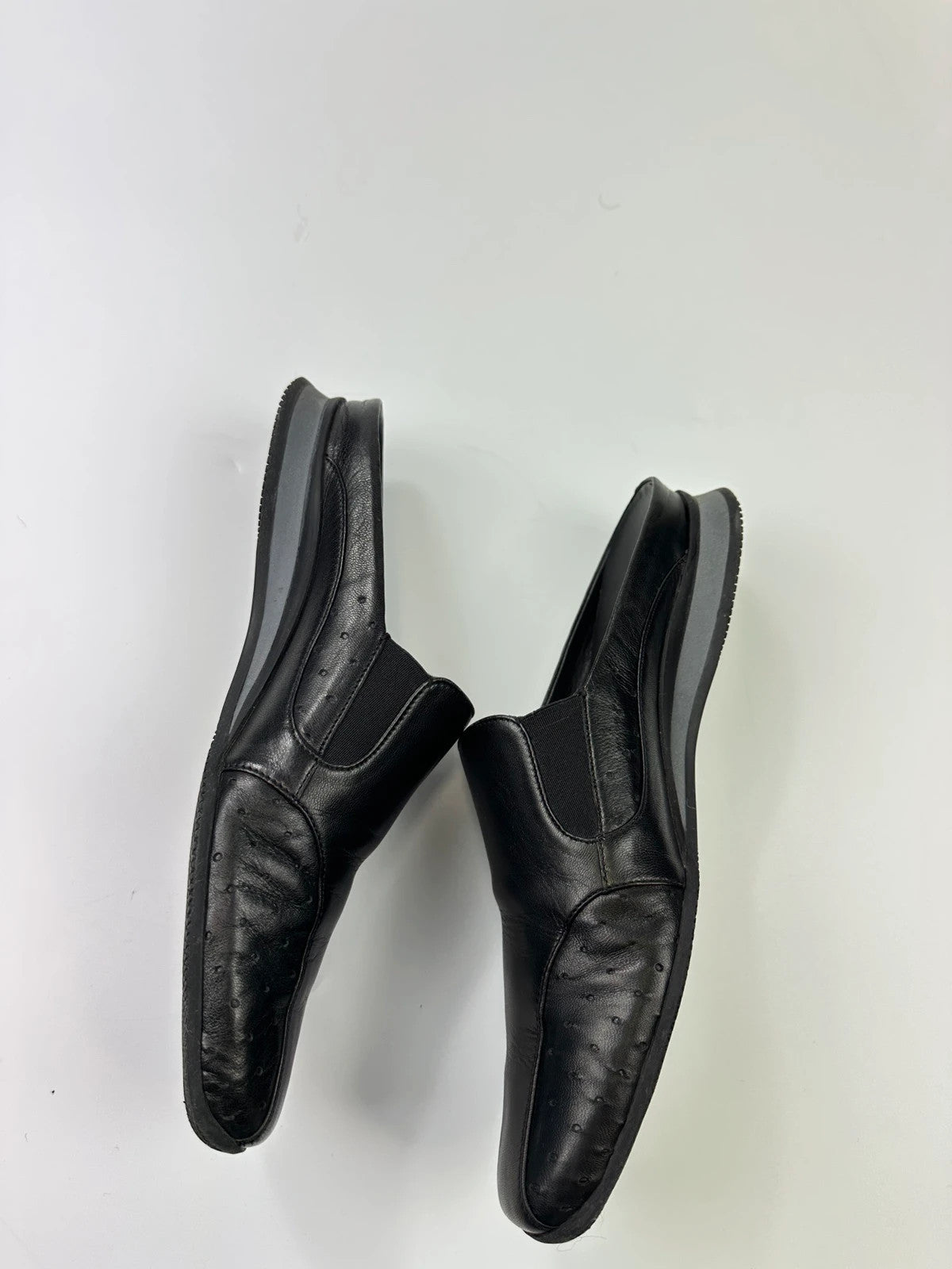 Prada black leather mules with ventilation, minimalist design from SS99 collection.