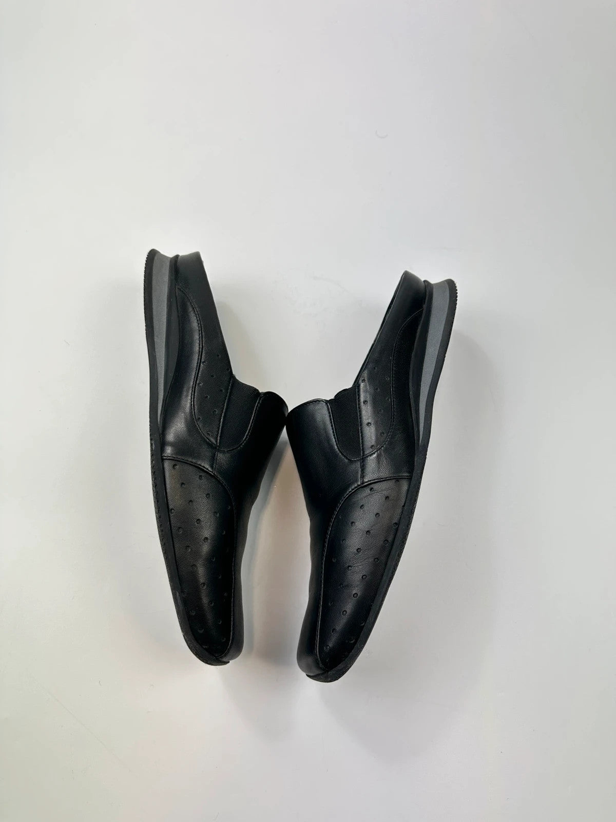 Prada black leather mules with ventilation, minimalist design from SS99 collection.