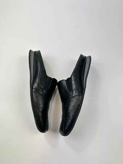 Prada black leather mules with ventilation, minimalist design from SS99 collection.