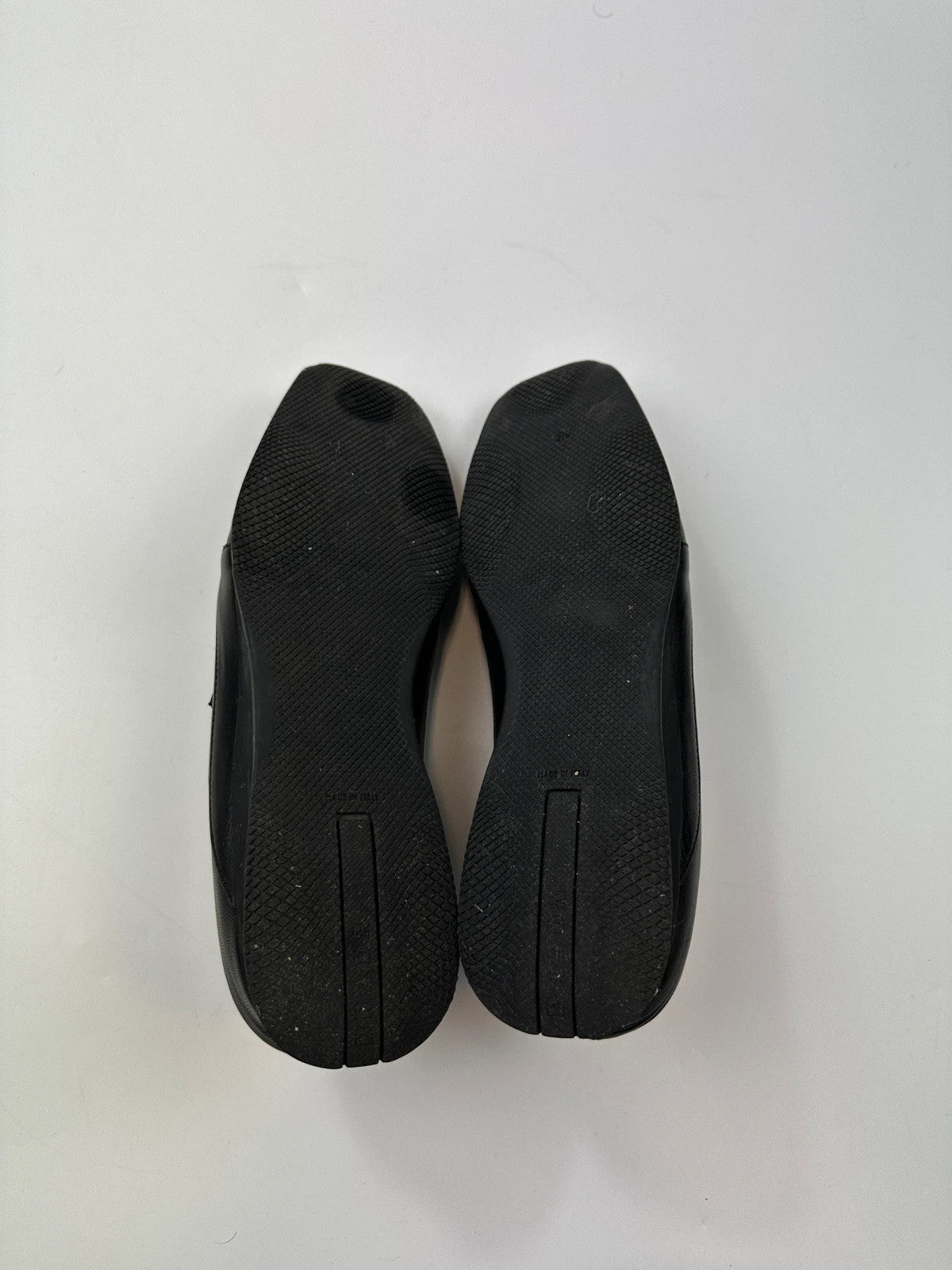 Prada black leather mules with ventilation, minimalist design from SS99 collection.