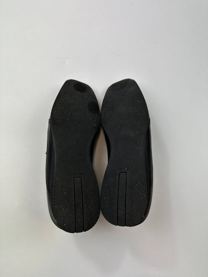 Prada black leather mules with ventilation, minimalist design from SS99 collection.