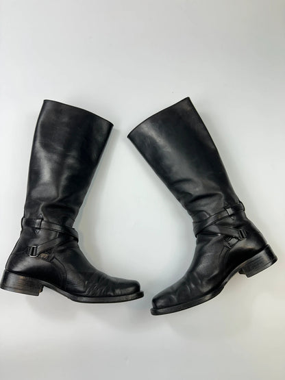 Prada black leather knee-high boots with high belt detail and minimalist design.