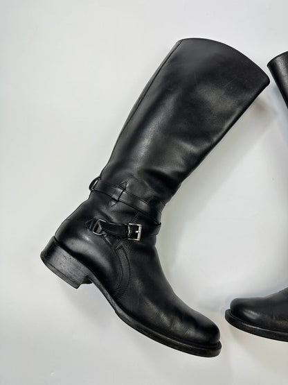 Prada black leather knee-high boots with high belt detail and minimalist design.