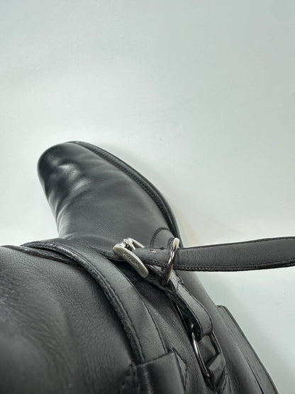 Prada black leather knee-high boots with high belt detail and minimalist design.