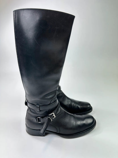 Prada black leather knee-high boots with high belt detail and minimalist design.