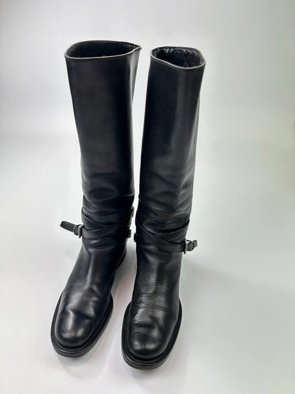 Prada black leather knee-high boots with high belt detail and minimalist design.