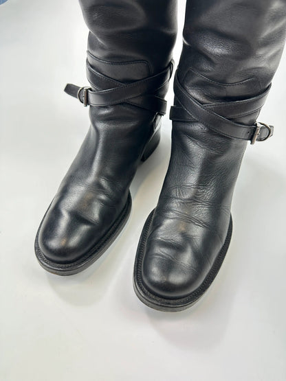 Prada black leather knee-high boots with high belt detail and minimalist design.