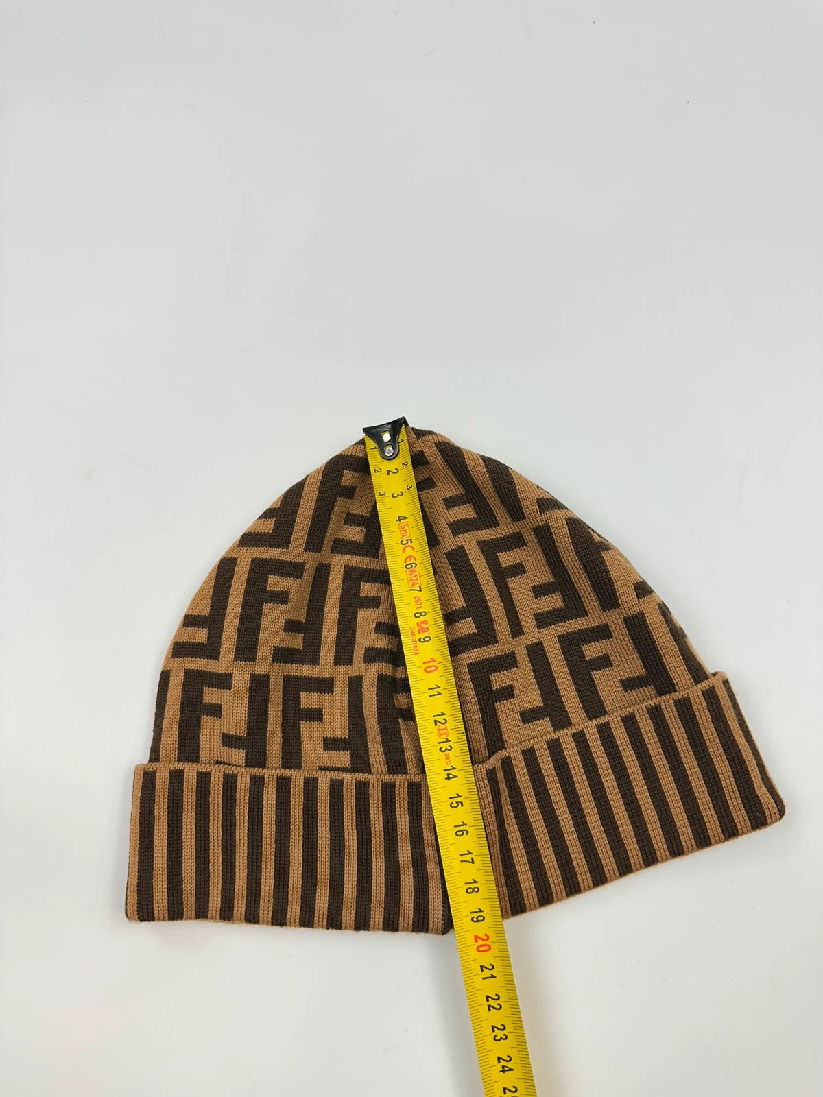 Fendi brown and mustard wool beanie featuring iconic FF monogram pattern.