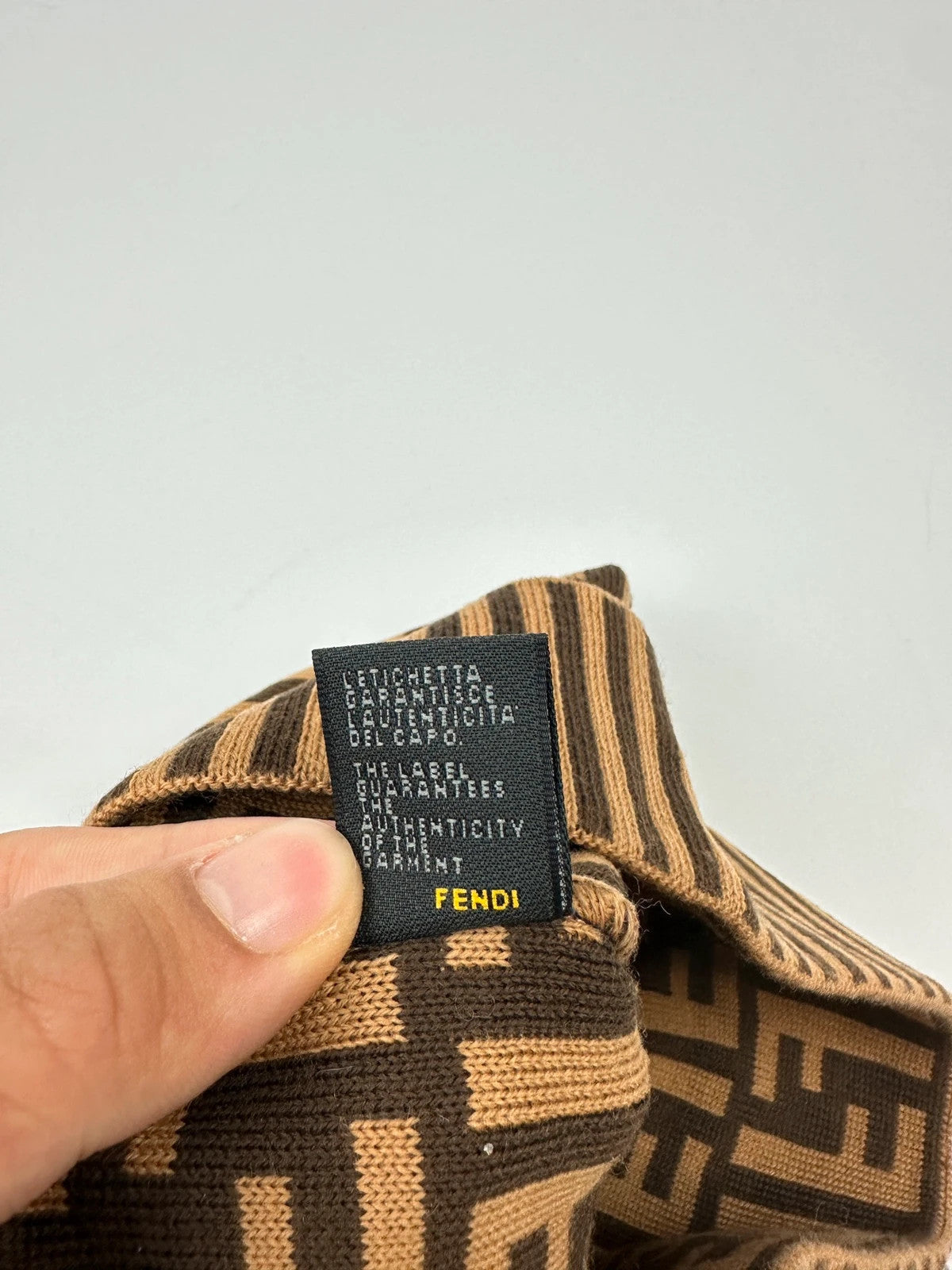 Fendi brown and mustard wool beanie featuring iconic FF monogram pattern.