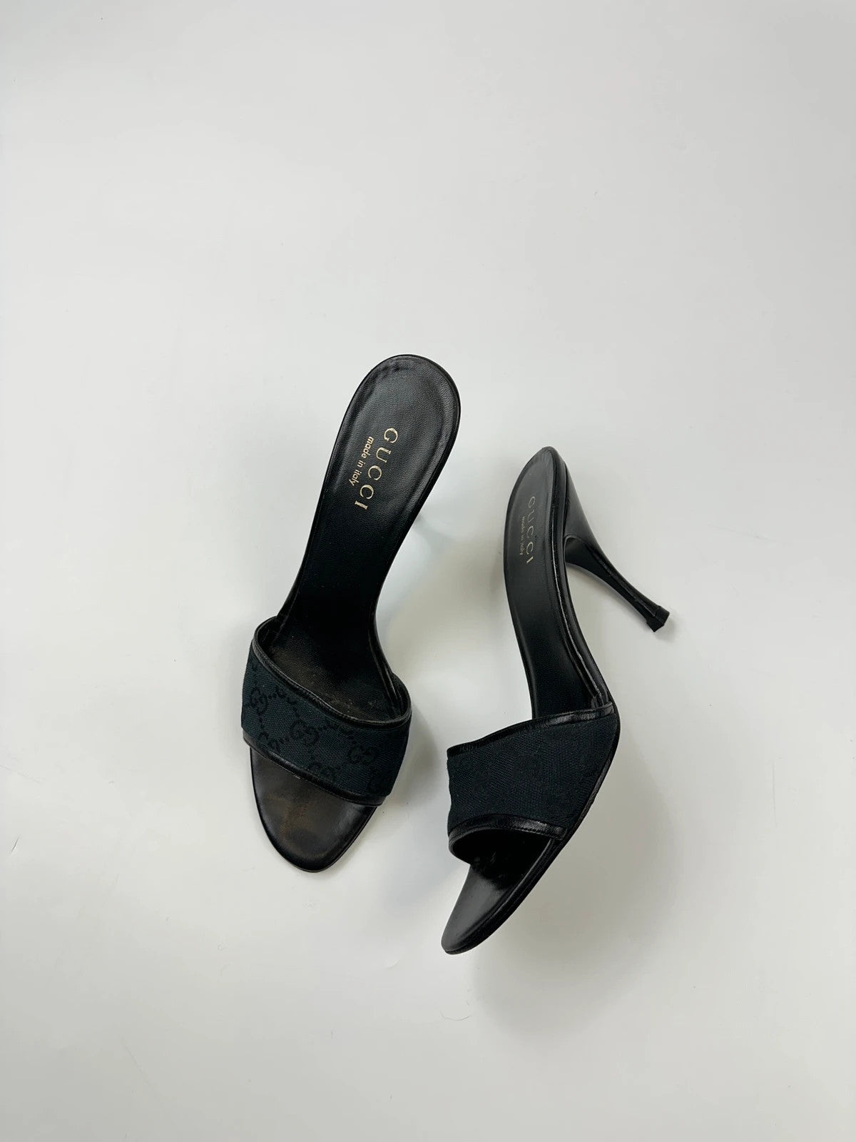 Gucci black heels with canvas monogram pattern and leather accents from the 2000s.