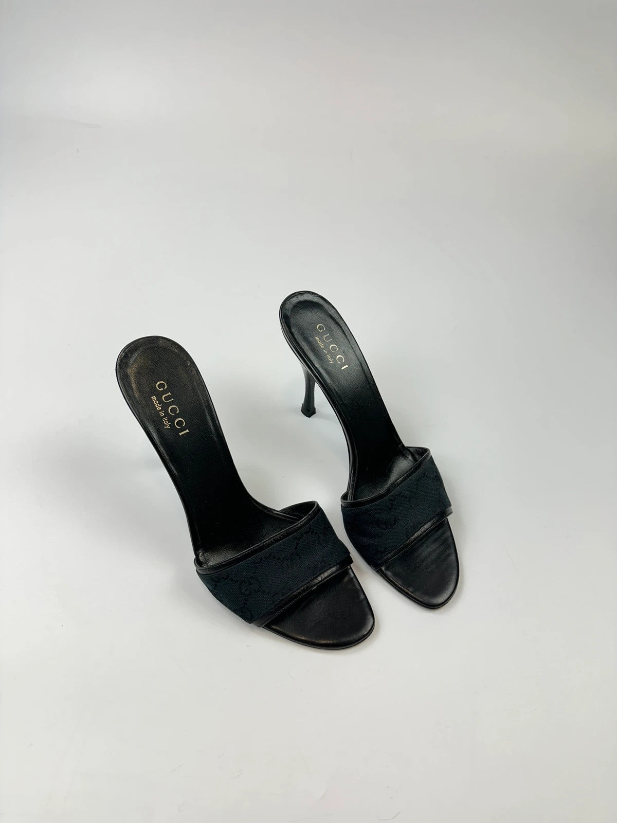 Gucci black heels with canvas monogram pattern and leather accents from the 2000s.