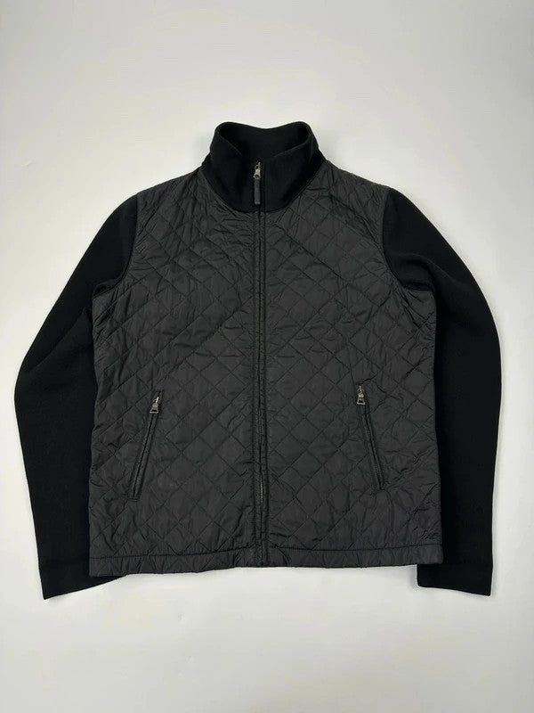 Prada black hybrid jacket with nylon body, wool sleeves, and padded detailing.